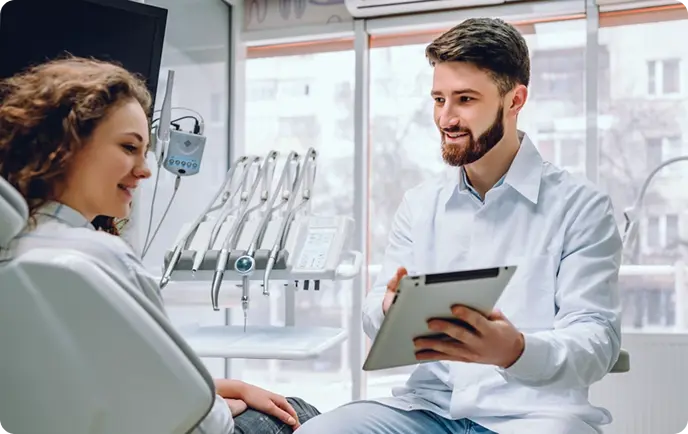 Dental consultation between dentist and patient discussing treatment options