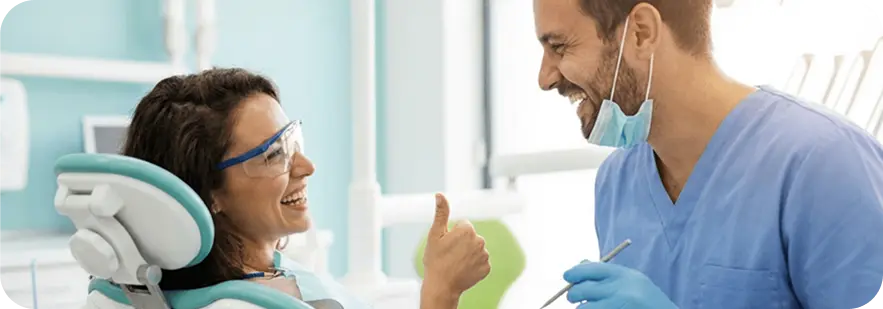 A man and woman sitting together in a dental office